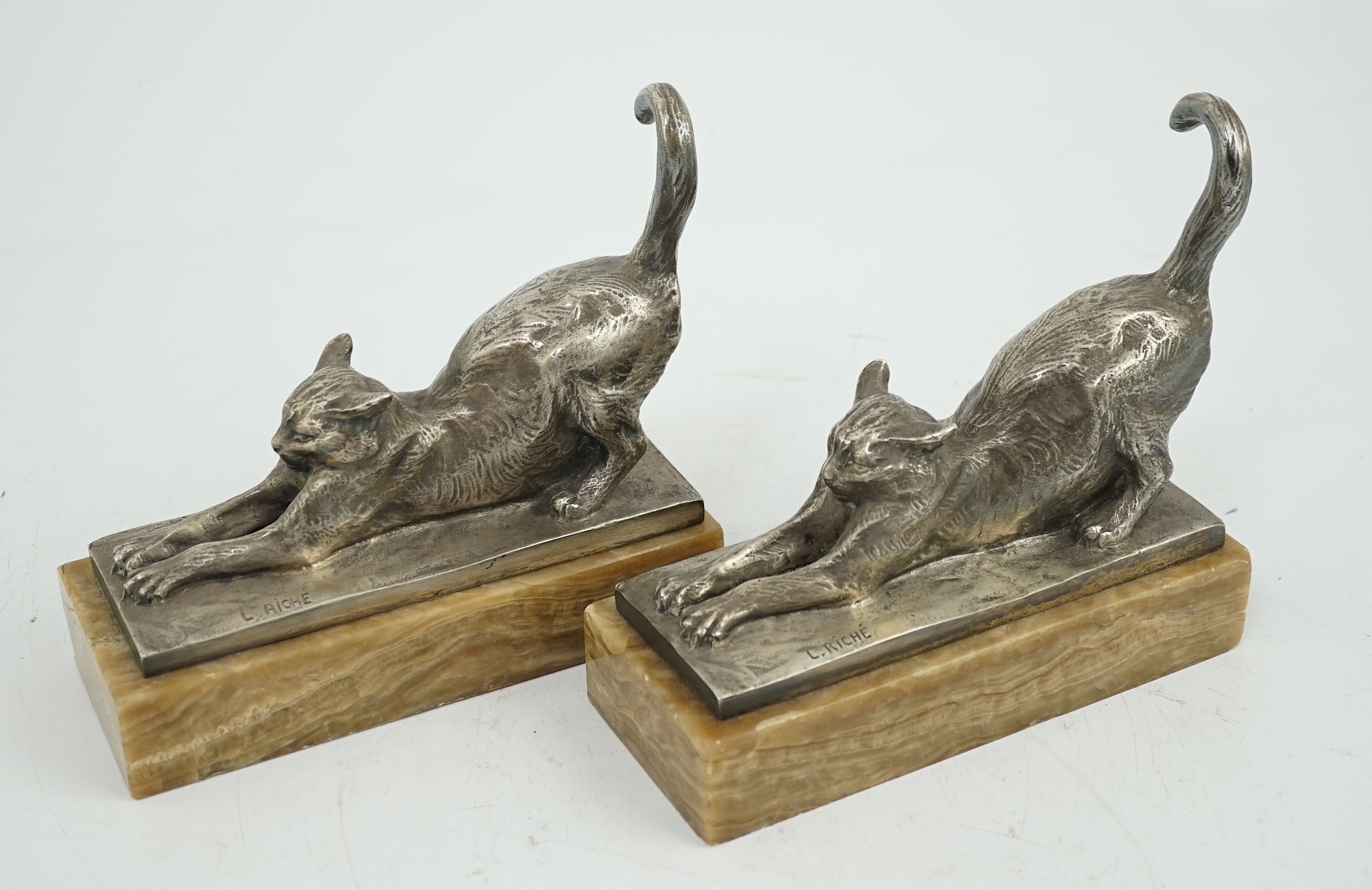 Louis Riché (French, 1877-1949), a pair of silvered bronze bookends modelled as stretching cats